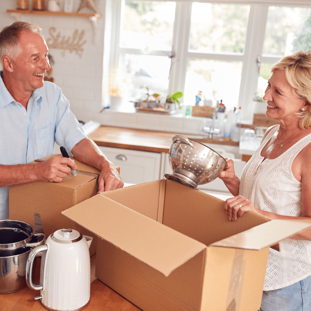 Older adult couple packing kitchenware